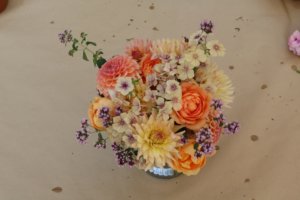 Vase with oregano, phlox, roses and dahlias