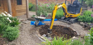 digging a garden pond with a mechanical digger